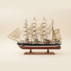 Passat four-masted barque wooden ship model perfect side profile view showing full silhouette, four masts with white square sails, black-and-white hull with red waterline, and wooden display base, 50 cm length, cream white background