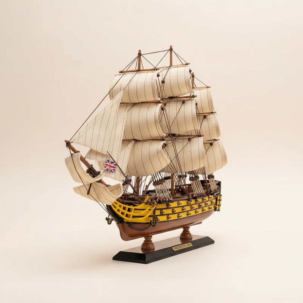 HMS Victory wooden ship model front view – three masts full white sails rope rigging yellow-black gun port hull display base