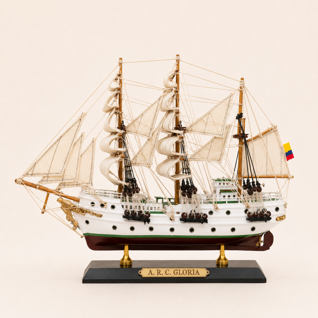 Side view of the A.R.C. Gloria ship model featuring a white hull, green stripe, cream fabric sails, wooden masts, detailed pulleys and rope rigging.