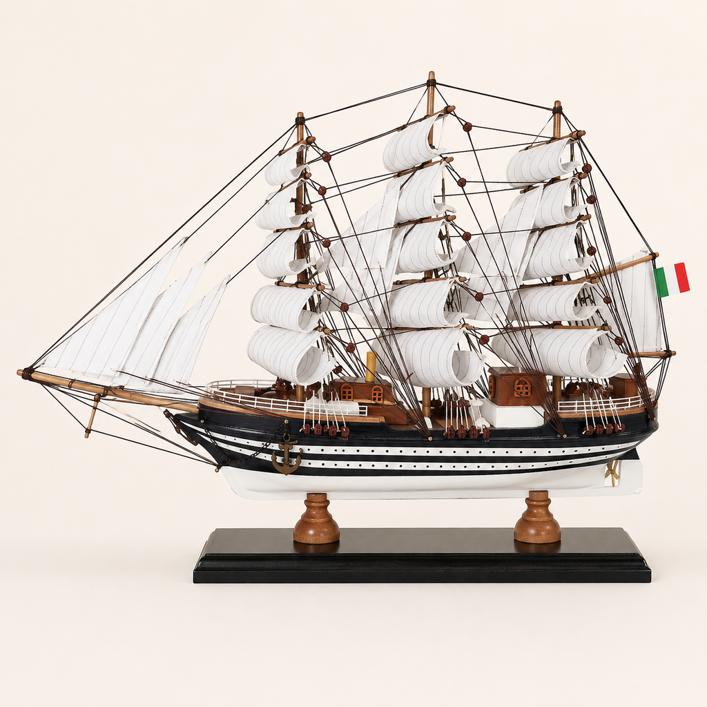 Side view of the Amerigo Vespucci wooden sailing ship model featuring three masts, layered white sails, black-and-white hull stripes, wooden deck cabins and black display stand.