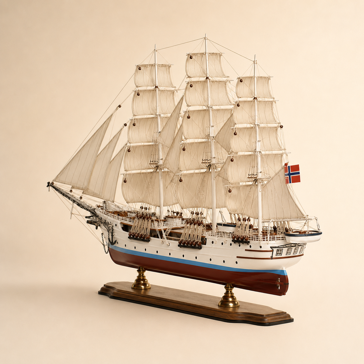 Rear 45-degree view of the Norwegian tall ship model showing the stern, rear deck, lifeboat, Norwegian flag, layered sails, rigging and polished wooden display base.