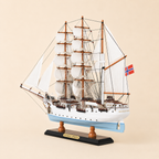Rear 45-degree view of the Statsraad Lehmkuhl wooden ship model showing the stern, rear deck, Norwegian flag, white sails, detailed rigging and black display stand.