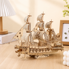 Wooden pirate ship model on a wooden surface with a neutral background