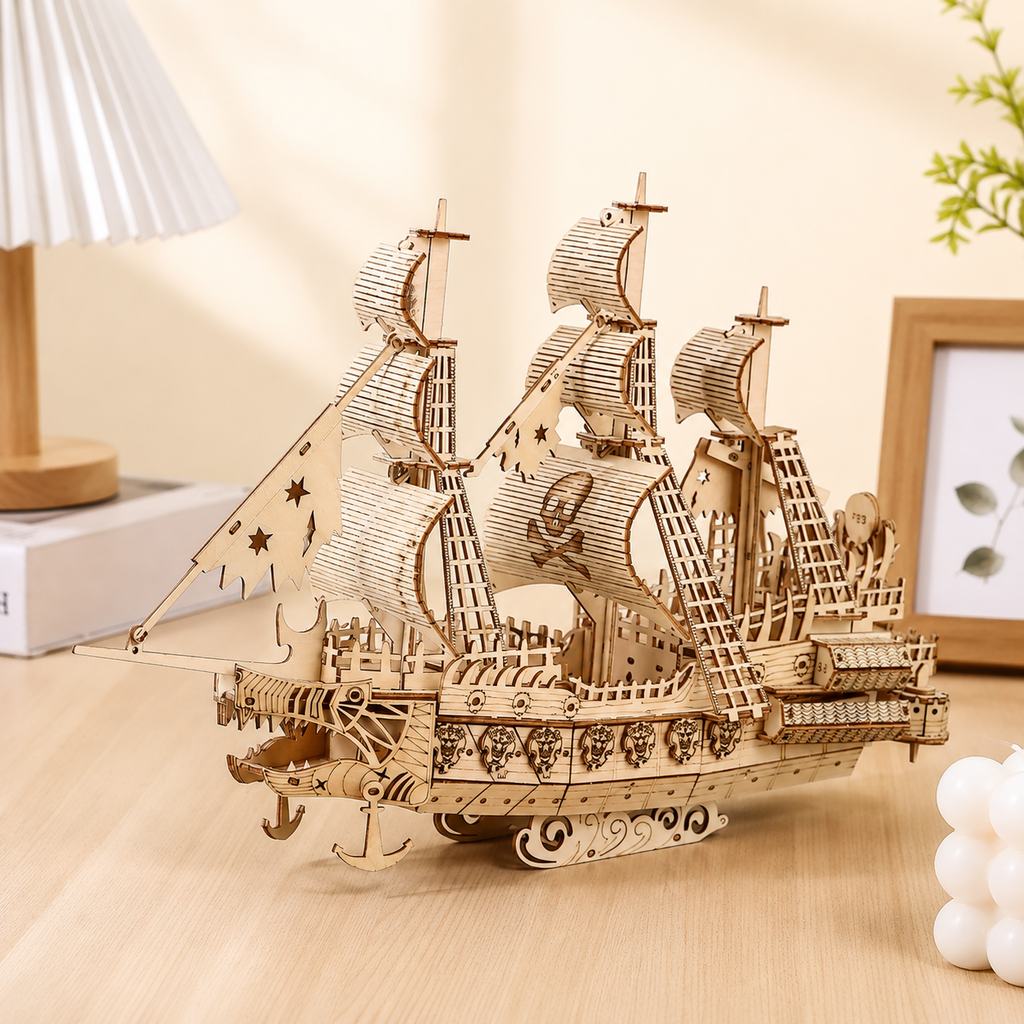 Wooden pirate ship model on a wooden surface with a neutral background