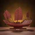 Side view of a Fu Chuan junk ship model showing three-mast full sail profile, miniature anchor, cannon ports, and carved hull inscription "福艟", warm amber background