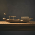 Side view of a Chinese cormorant fishing boat model with cormorant bird perched on bow pole, woven straw cabin, and wooden oar, warm studio light