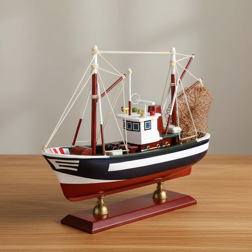 Handcrafted American shrimp boat wooden ship model on warm wooden desk – navy blue hull with white stripe, white wheelhouse, red outrigger booms, white rope rigging, metal fishing net, mahogany base with brass feet, coastal nautical home decor
