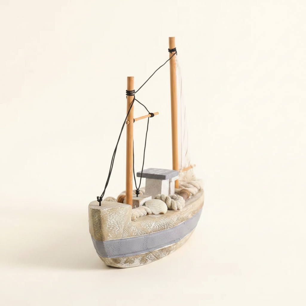 Mediterranean fishing boat wooden model front 3/4 view – wide low hull with weathered white-grey finish and grey waterline stripe, two wooden masts, black rope rigging, linen sail, rope coils and seashell deck details, cream white background