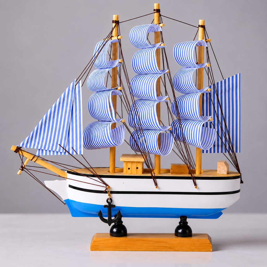 Model ship with blue and white striped sails on a gray background