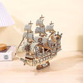 Wooden ship model on a wooden surface with a neutral background