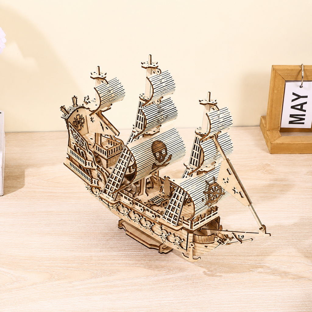 Wooden pirate ship model on a wooden surface