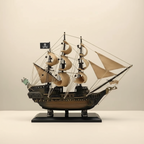 Black Pearl pirate ship model full side profile – complete silhouette showing dark resin hull, multiple masts with billowing canvas sails, intricate rope rigging, Jolly Roger flag, and black display base, cream white background