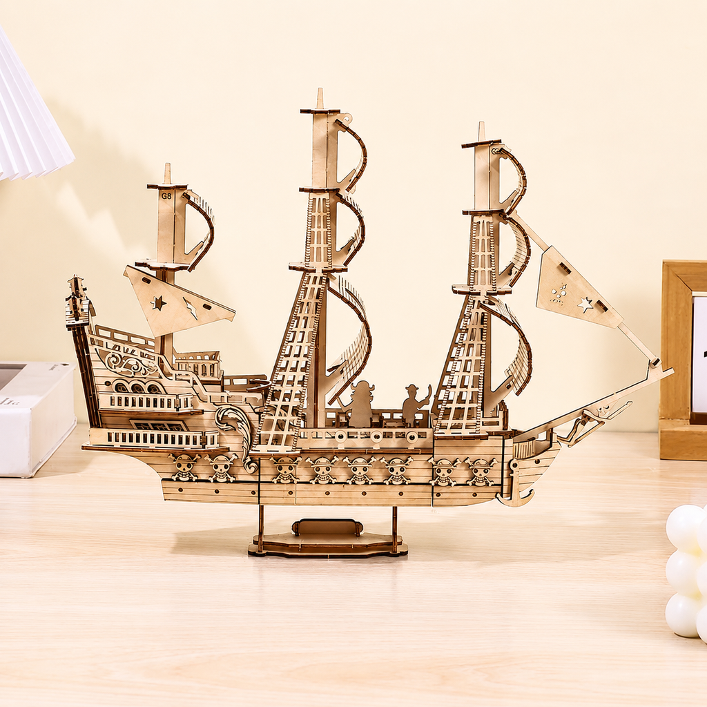 Wooden model of a pirate ship on a wooden surface with a neutral background
